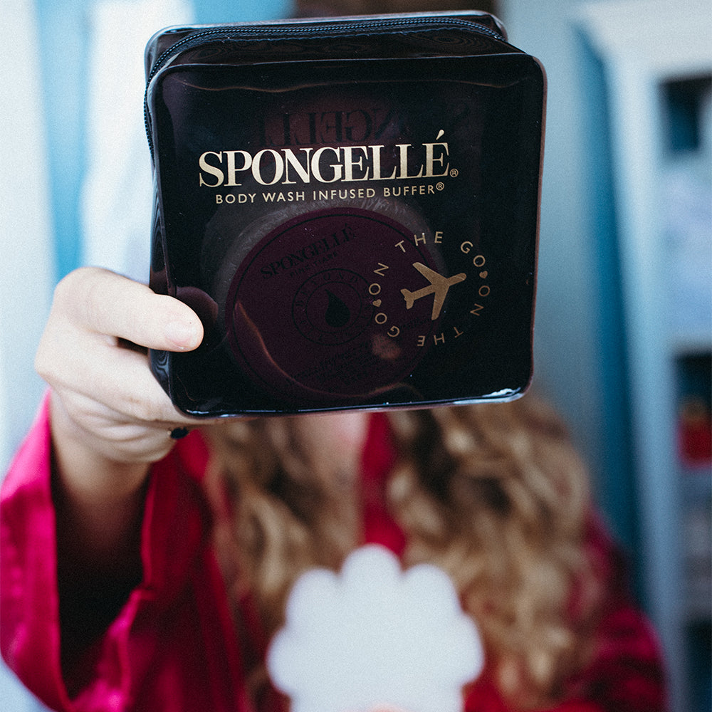 Black Spongellé travel case with zipper closure, designed for storing toiletries and travel essentials.