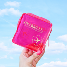 Pink Spongellé travel case with a compact, protective design for storing toiletries and travel essentials.