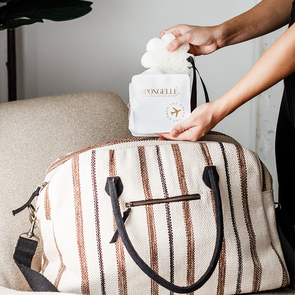 White Spongellé travel case with a compact, durable design for storing toiletries and spa products on the go.