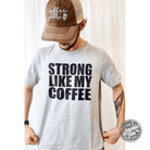 Unisex graphic T-shirt featuring "Strong Like My Coffee" slogan, made by The Graphic Tee, casual apparel for men and women.