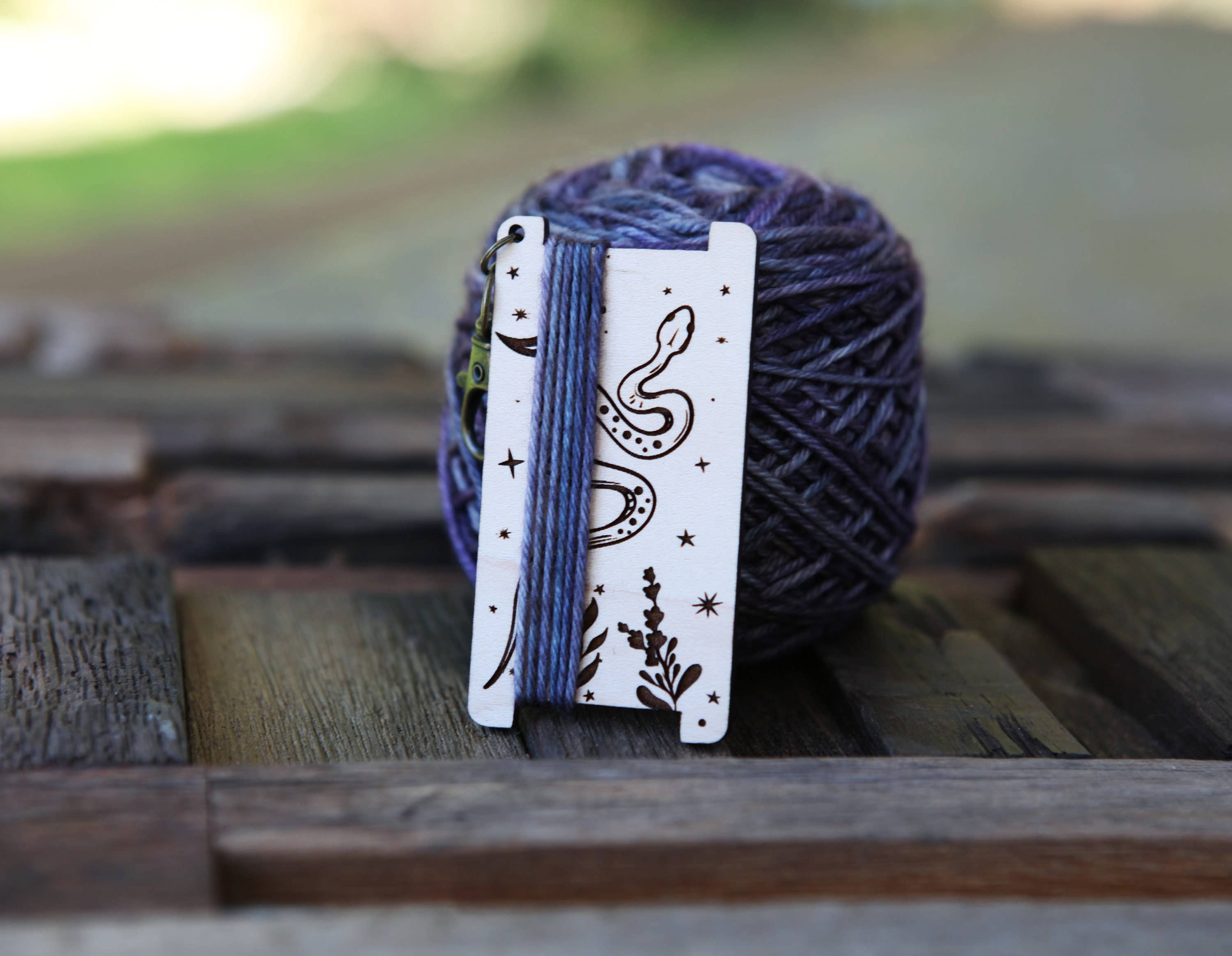 Mountaintop Yarn Crescent Moon and Stars Snake WPI gauge ruler with forest plant design, showcasing intricate botanical details.