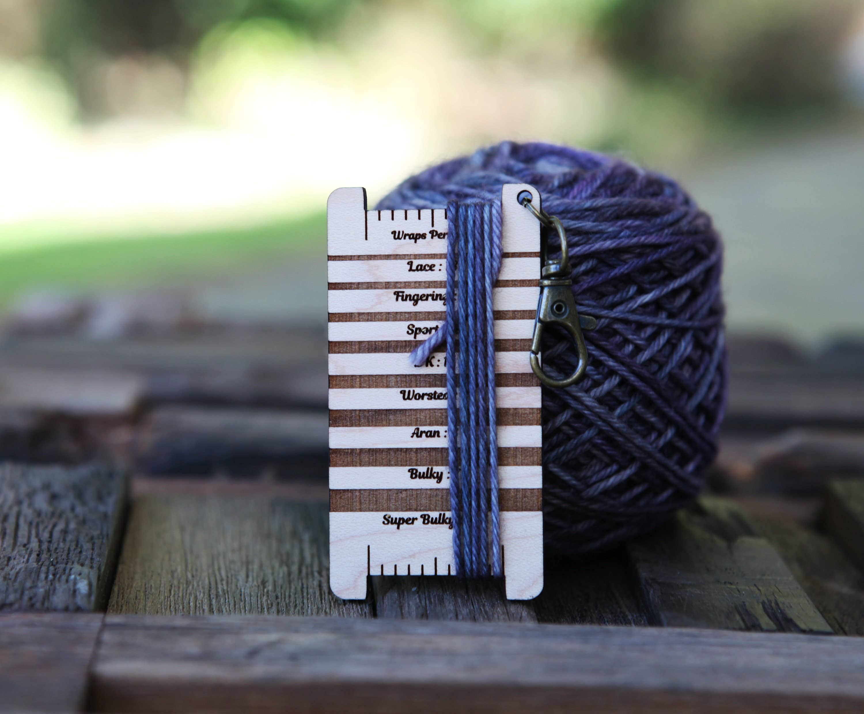 Mountaintop Yarn Crescent Moon & Stars Snake WPI gauge ruler with forest plant design, ideal for measuring yarn thickness.