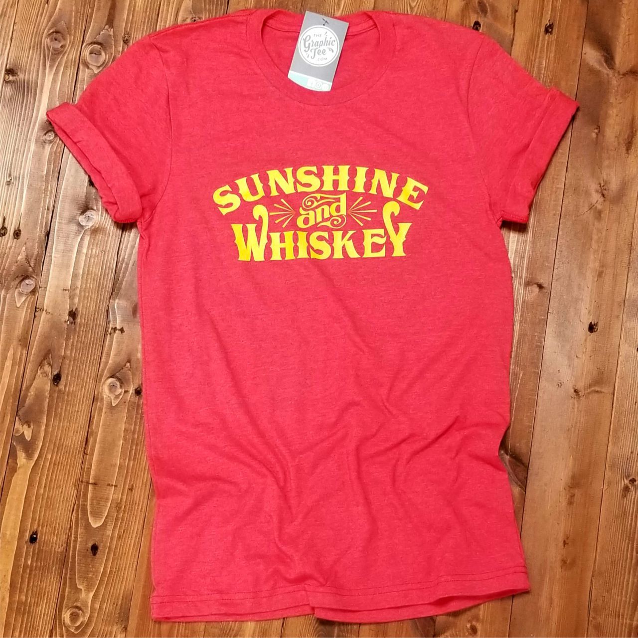 Sunshine and Whiskey unisex SS graphic tee by The Graphic Tee, featuring a vibrant sun and whiskey design on soft cotton fabric.