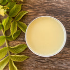 Lavender balm by Sweet ʻŌkole Soap, calming essential oil salve in a small jar with lavender flowers and herbal ingredients.