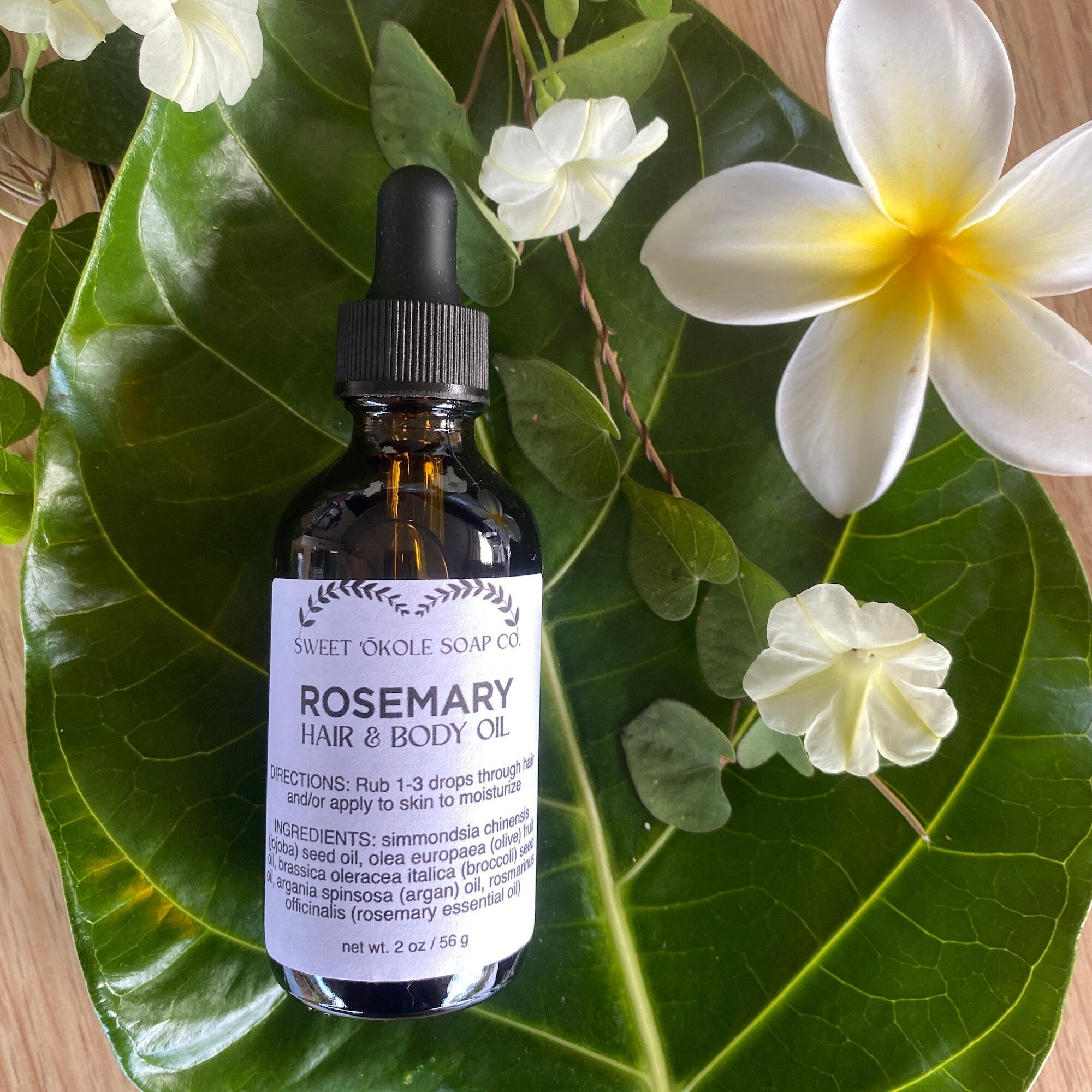 Bottle of Sweet ʻŌkole Soap Rosemary Hair & Scalp Oil with a dropper, positioned on a white background.