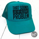 Jade foam trucker cap with the humorous phrase "That Sounds Like My Husband's Problem" from The Graphic Tee.