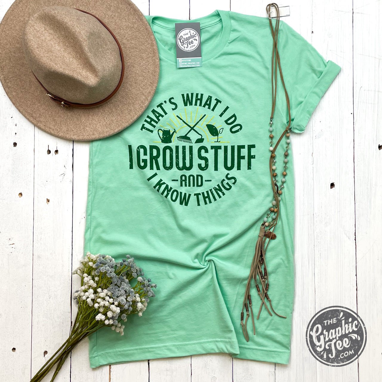 That's What I Do I Grow Stuff short sleeve graphic tee by The Graphic Tee, featuring a plant-themed design on a casual tee.