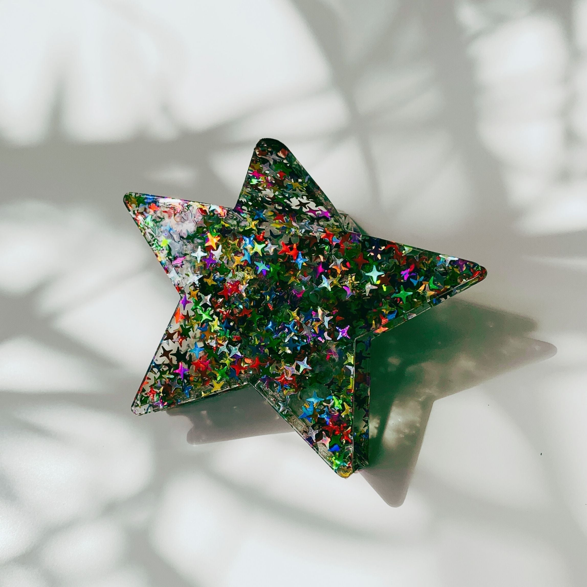 Velvet Claws Glitter Star Hair Claw accessory with star-shaped design and sparkly finish, perfect for stylish hair styling.
