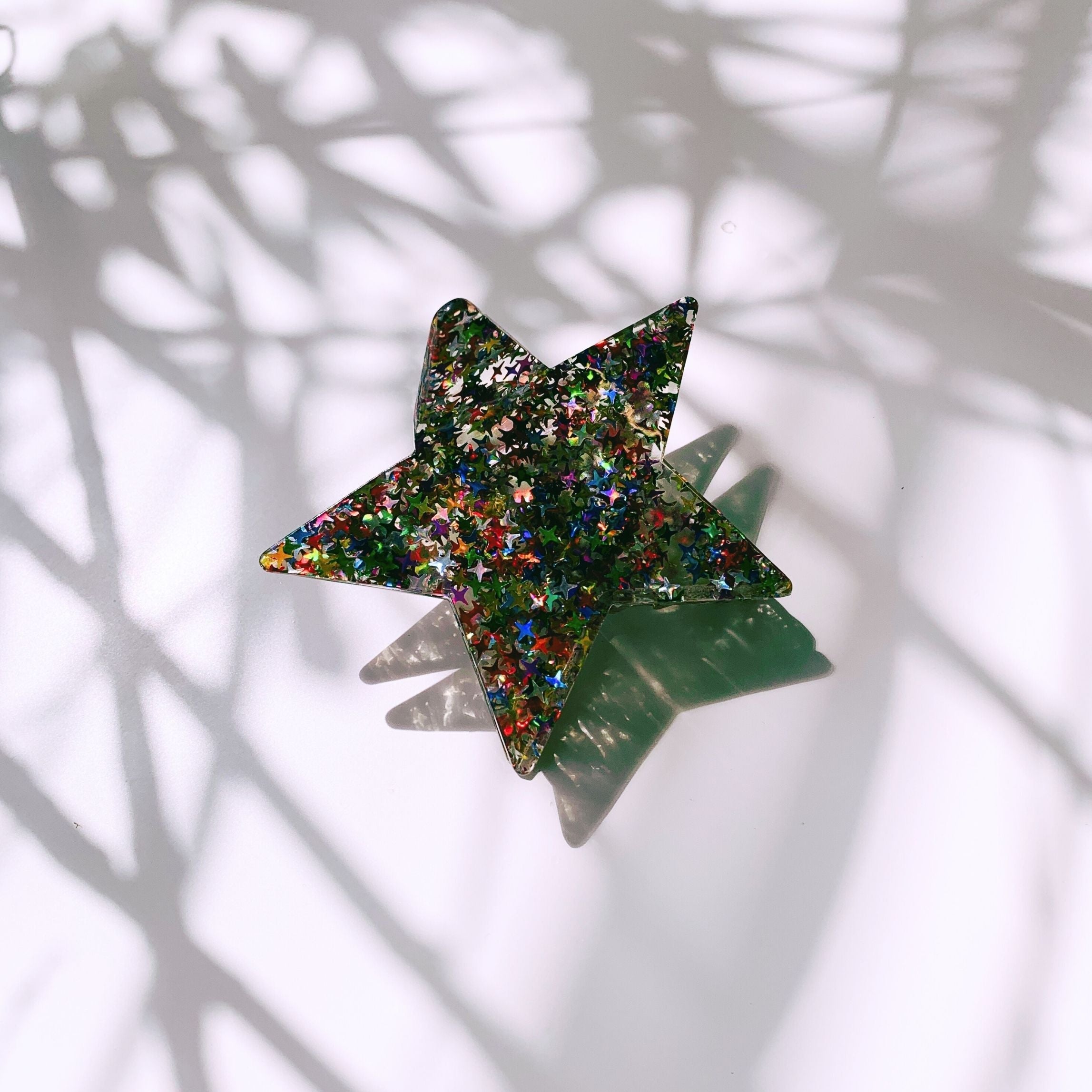 Velvet Claws glitter star hair claw accessory with a velvet finish and sparkling star design, ideal for stylish hair styling.