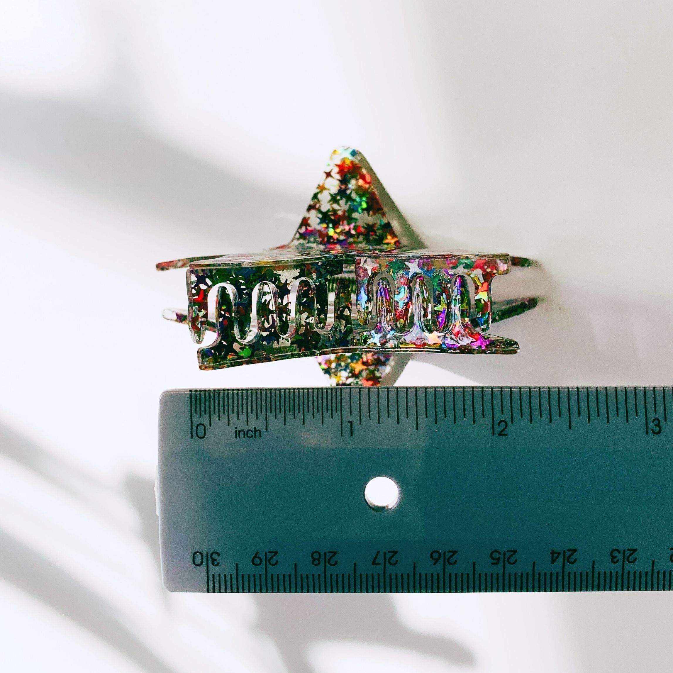 Velvet Claws glitter star hair claw accessory with purple and silver accents, suitable for stylish hair styling and decorative use.