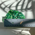 Velvet Claws Monstera leaf hair claw accessory by The Bullish Store, featuring a green monstera leaf design on a velvet hair clip.