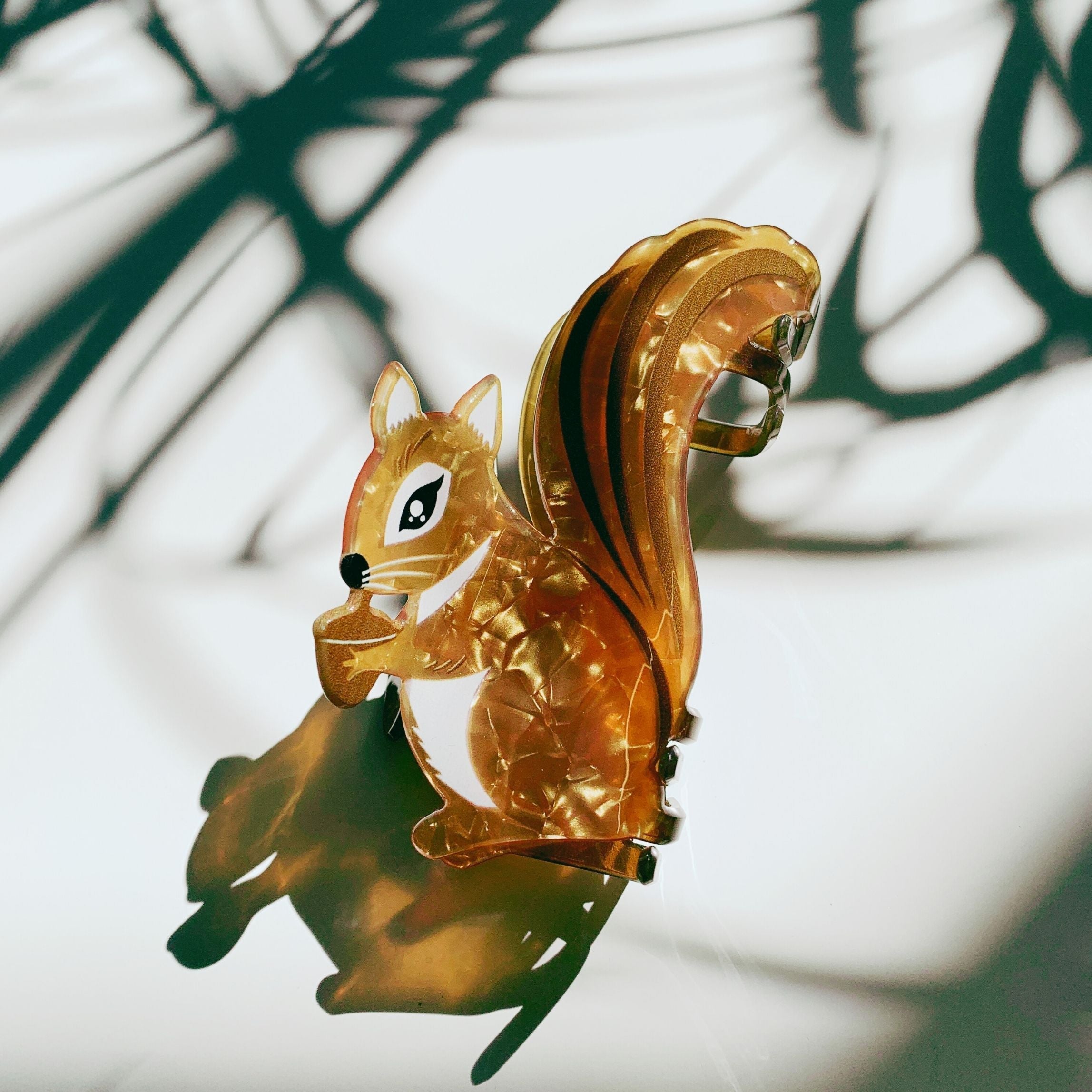 Velvet Claws squirrel hair claw clip holding an acorn, with a plush velvet finish, designed for stylish hair accessories.