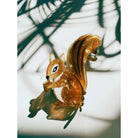Velvet Claws squirrel hair claw clip holding an acorn, featuring soft velvet material and detailed squirrel design, suitable for hair accessories.