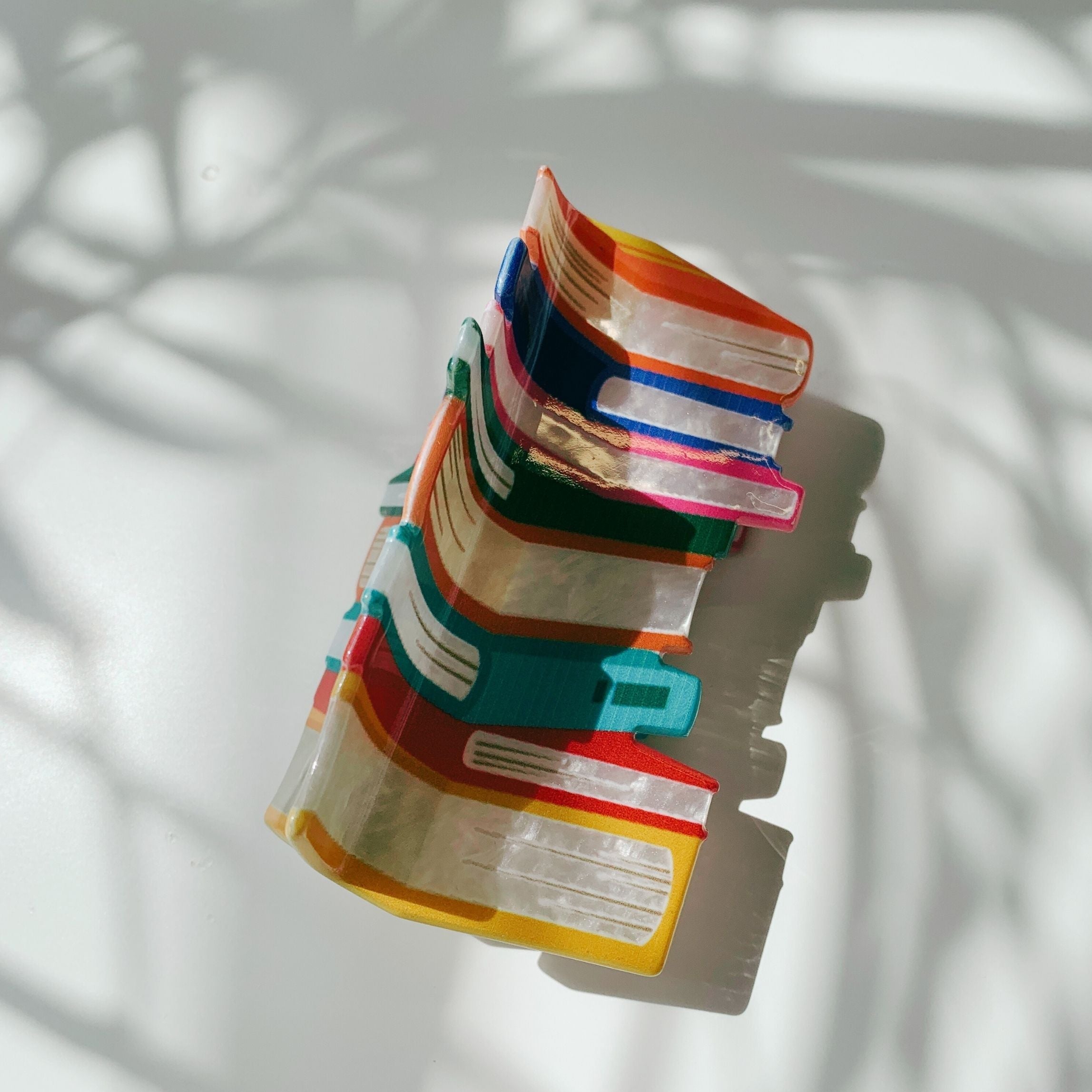 Velvet Claws stack of books hair clip by The Bullish Store featuring a velvet claw design in a travel-friendly bag.
