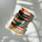 Velvet Claws stack of books hair clip in a velvet travel bag, stylish accessory from The Bullish Store with claw design.