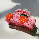 Velvet Claws strawberry granny square hair claw by The Bullish Store, featuring colorful woven fabric and a claw clasp.