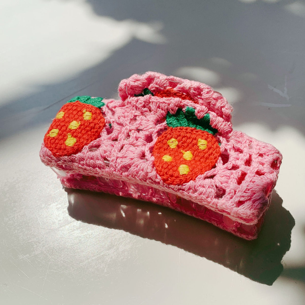 Velvet Claws strawberry granny square hair claw by The Bullish Store, featuring colorful woven fabric and a claw clasp.