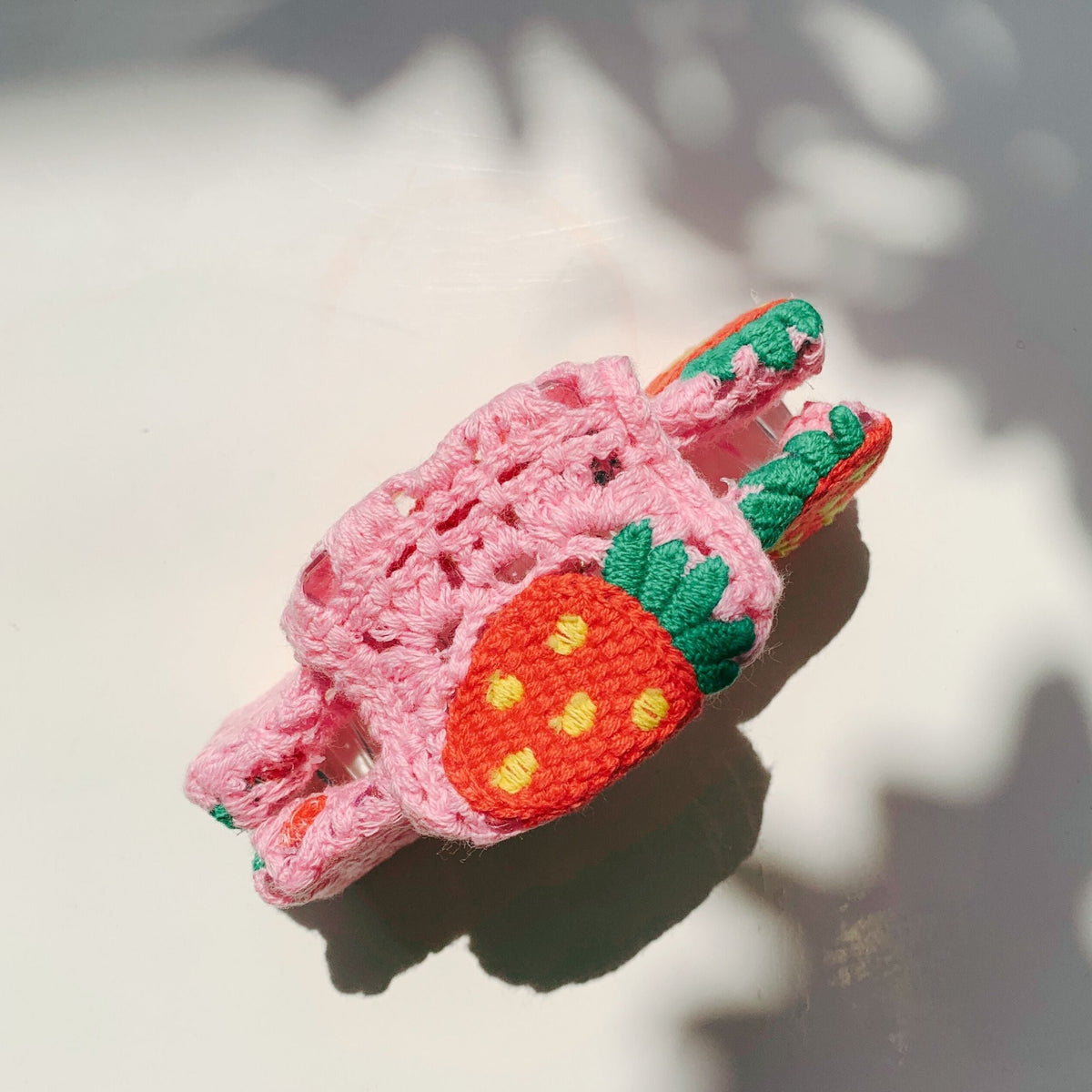 Velvet Claws strawberry granny square hair claw from The Bullish Store, featuring a soft, textured accessory for styled hair.