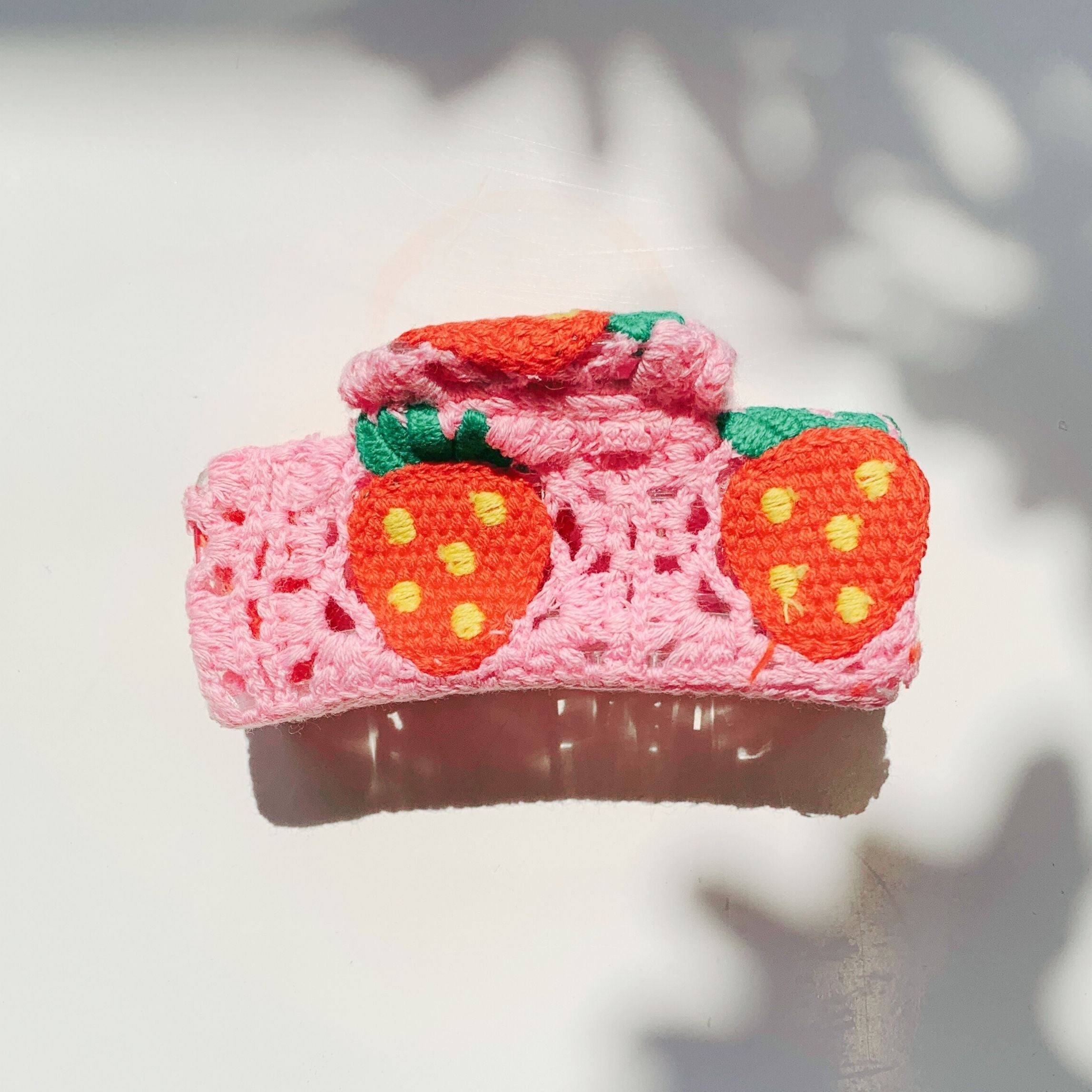 Velvet Claws Strawberry Granny Square Hair Claw from The Bullish Store, featuring a colorful crochet pattern accessory for hair.