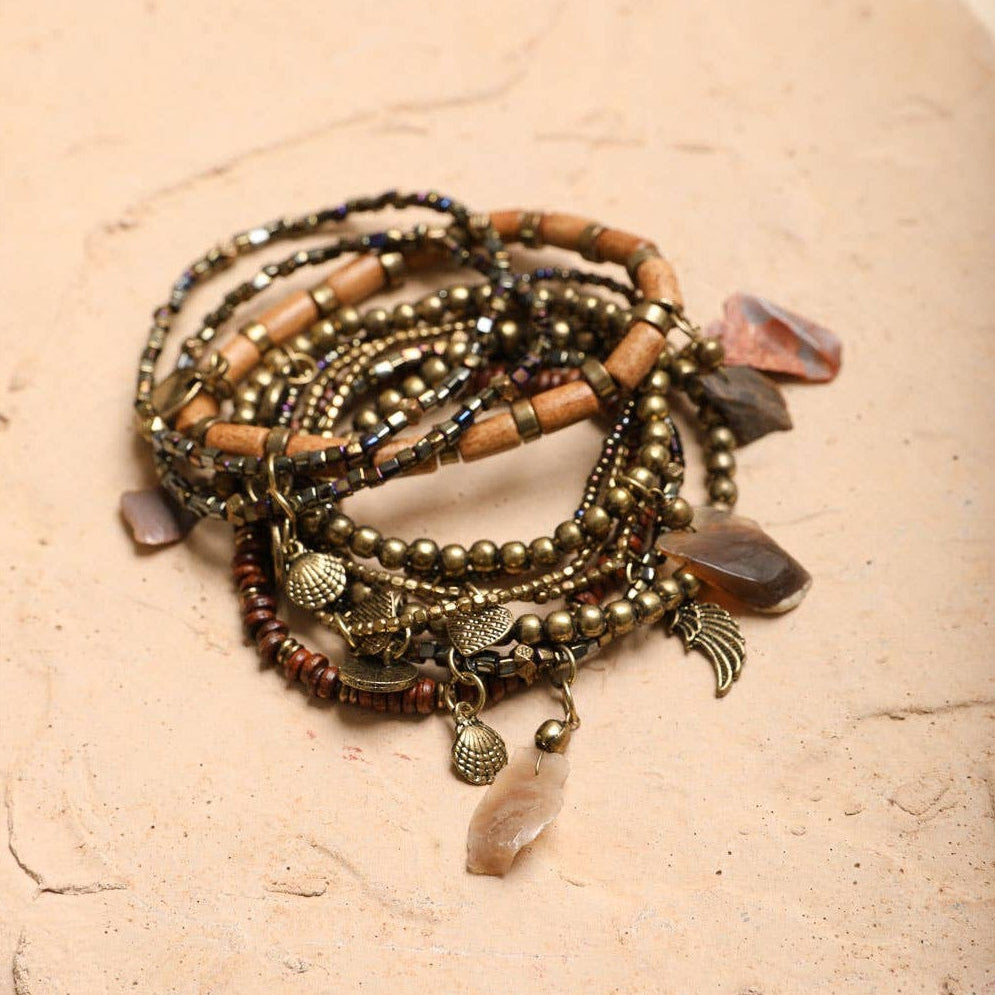 Stack of 10 boho stone and bead stretch bracelets from The Bullish Store, featuring colorful, stackable jewelry for a stylish look.