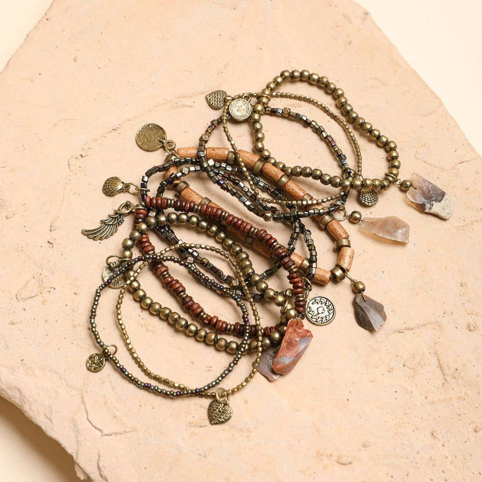 Stack of 10 boho stone and bead stretch bracelets from The Bullish Store, showcasing colorful, stackable jewelry for bohemian style.