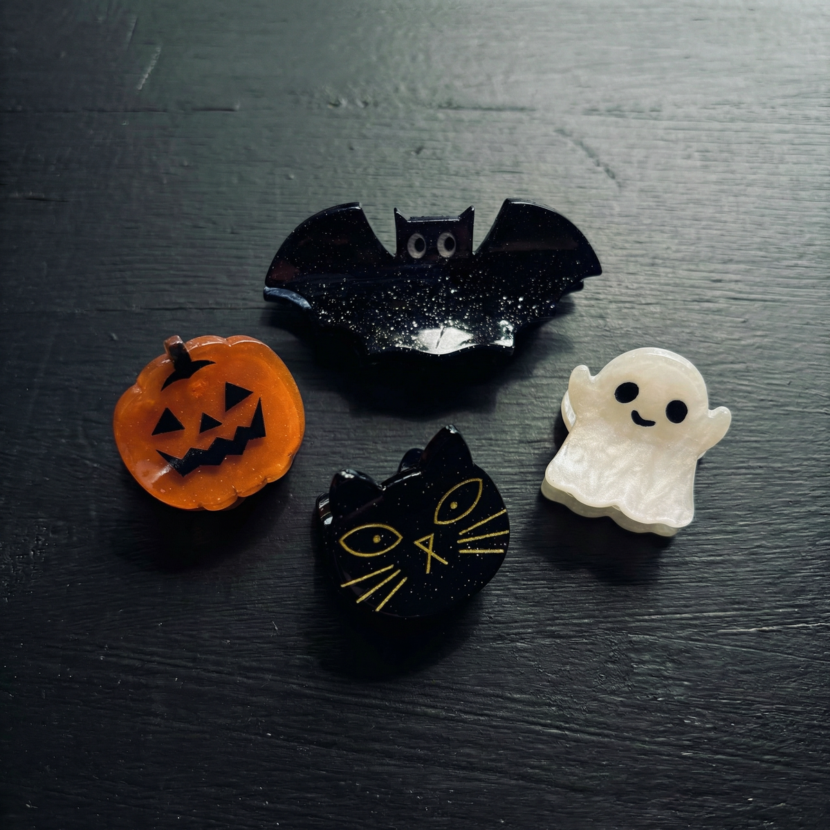 Set of 4 velvet mini spooky hair claw clips from The Bullish Store in a giftable pouch, perfect for securing small sections of hair.