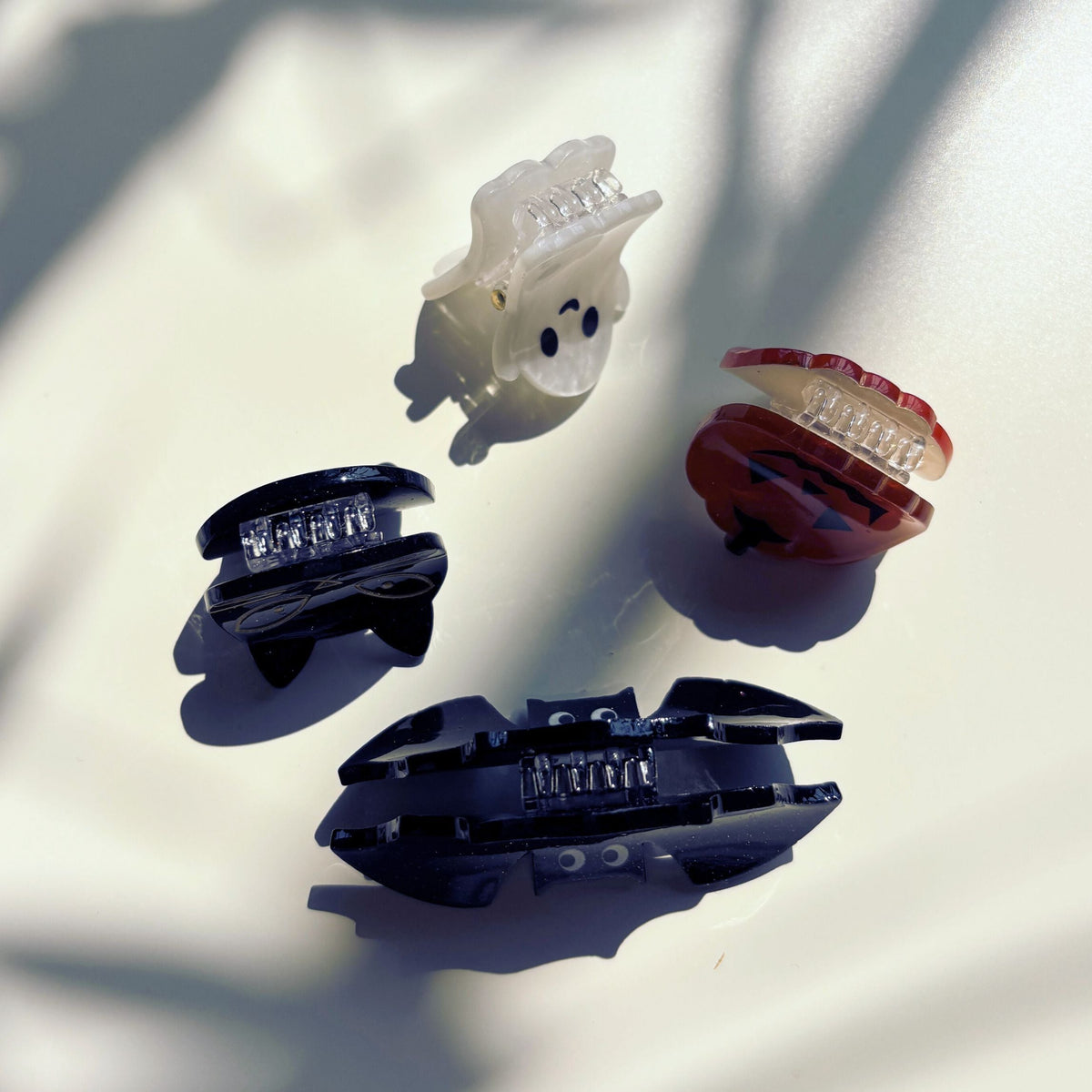 Set of 4 velvet mini spooky hair claw clips from The Bullish Store in a giftable pouch, perfect for stylish hair accessories.