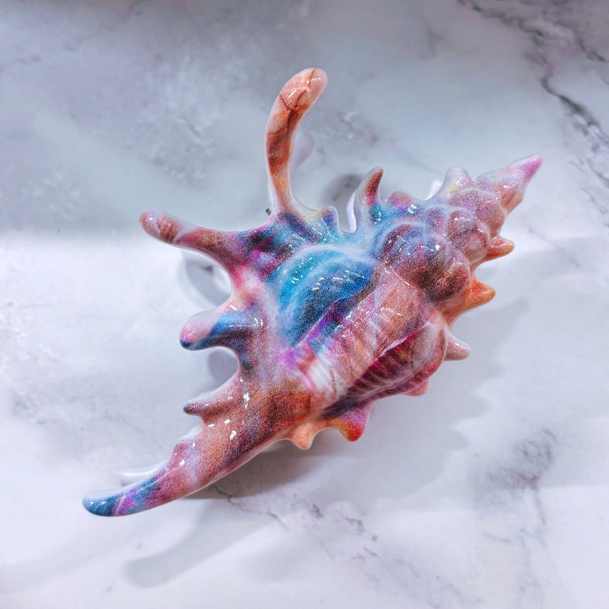 Velvet Claws realistic conch shell hair clip in mermaid colors, stylish accessory from The Bullish Store for hair styling.
