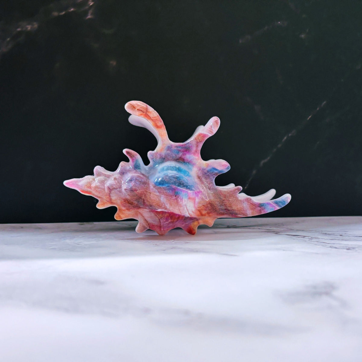 Velvet Claws realistic conch shell hair clip in vibrant mermaid colors, stylish and decorative hair accessory.