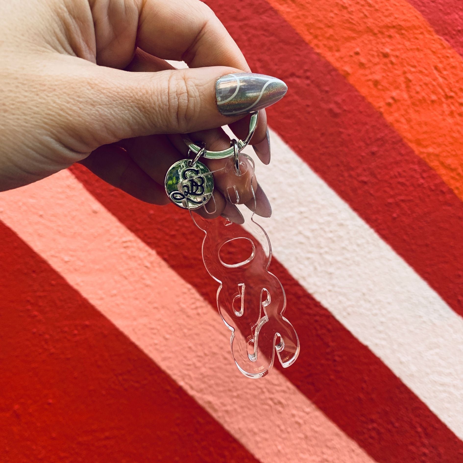 Clear acrylic Boss word keychain from The Bullish Store featuring a transparent, word-shaped design.