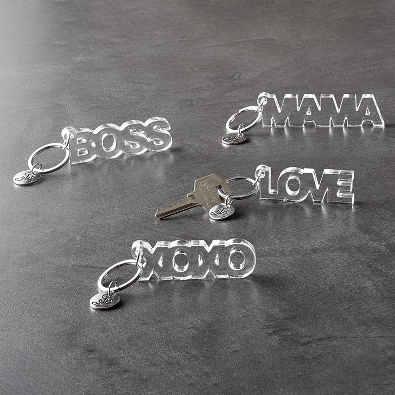 Clear acrylic Boss word keychain from The Bullish Store, transparent and word-shaped keyholder with a sleek, modern design.