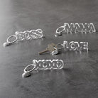 Clear acrylic Boss word keychain from The Bullish Store, transparent and word-shaped keyholder with a sleek, modern design.