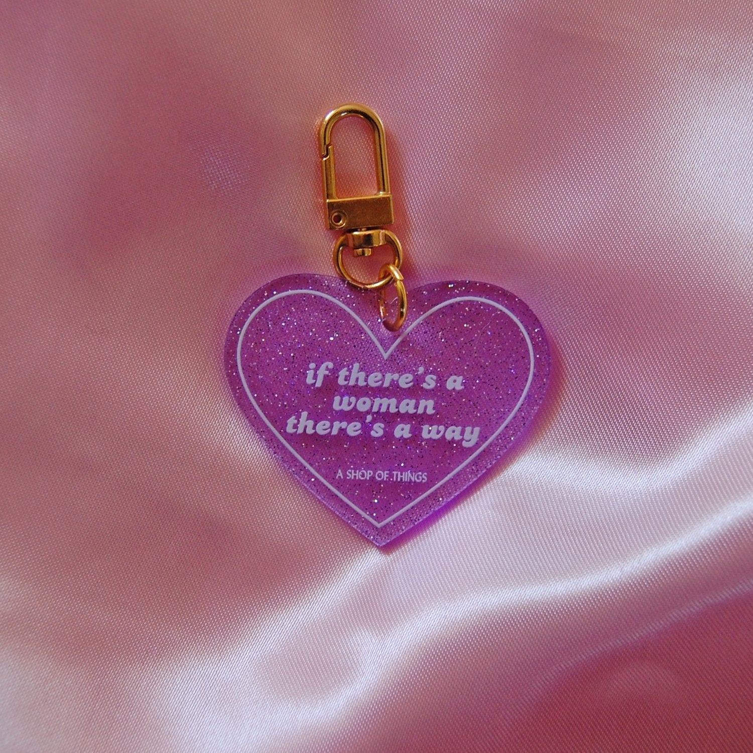 Heart-shaped keychain featuring the phrase "If There's A Woman There's A Way" by The Bullish Store, displayed on a plain background.
