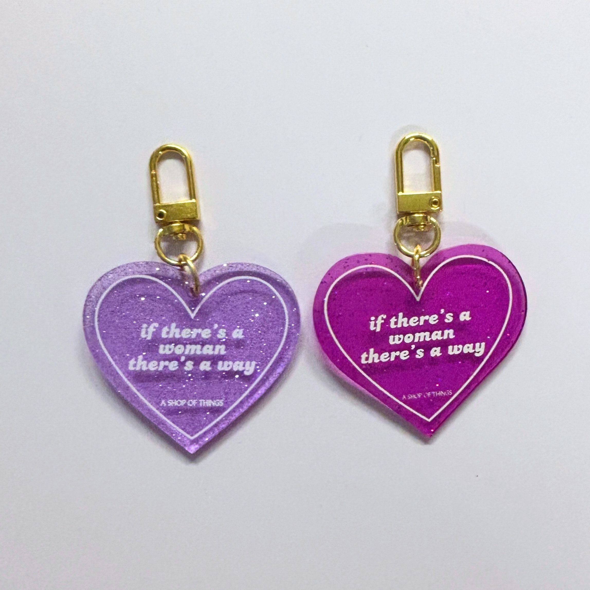 Heart-shaped keychain with "If There's A Woman There's A Way" message, featuring a metal keyring and decorative design.