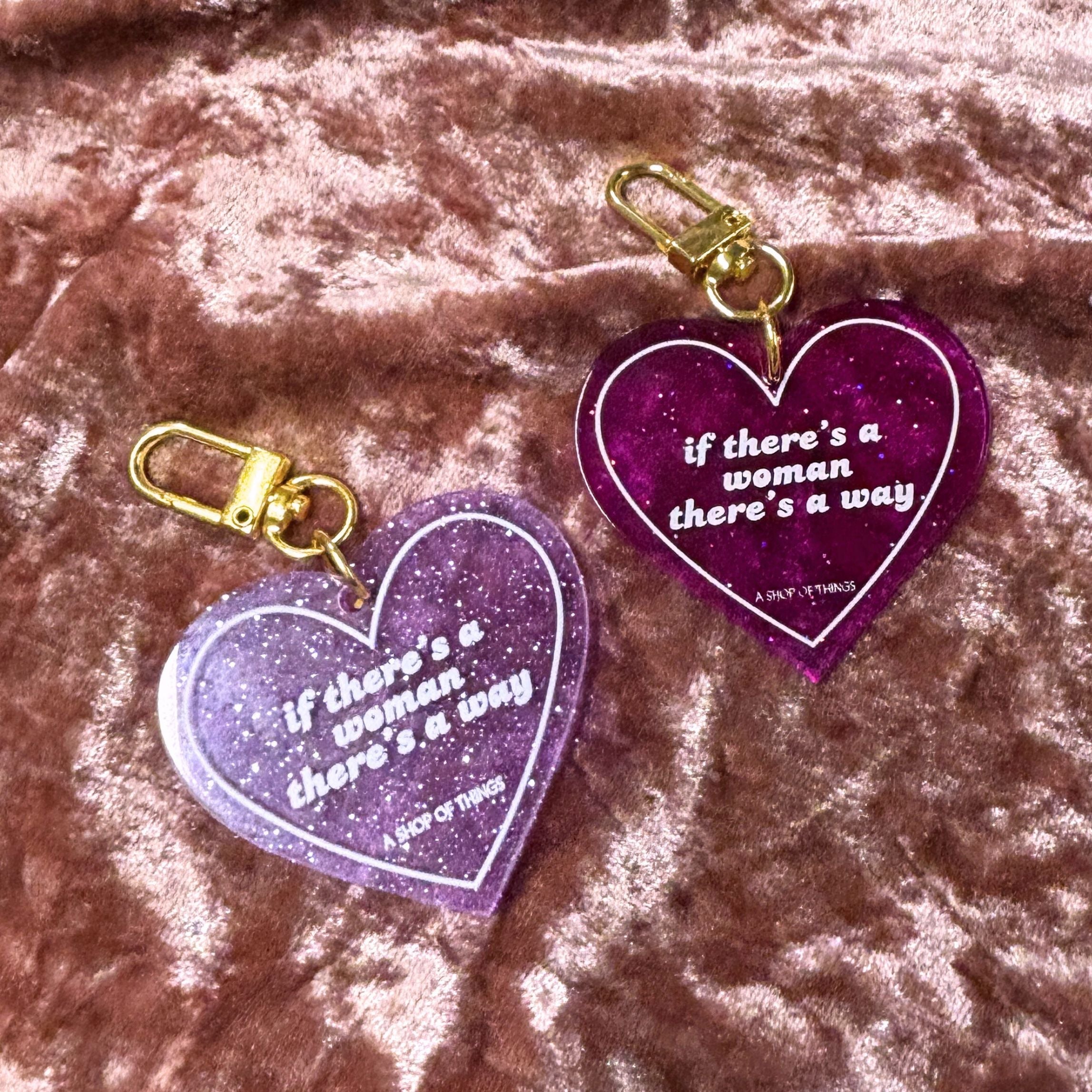 Heart-shaped keychain with "If There's A Woman There's A Way" inscription from The Bullish Store on shiny metal.