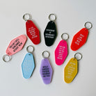 Black Motel Style keychain from the Department of Redundancy Department, featuring humorous motel-themed design.