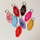 Black Motel Style keychain from the Department of Redundancy Department, featuring bold branding and durable metal construction.
