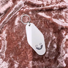 White vintage motel keychain featuring mood stabilizer design, from The Bullish Store, ideal for keys or as a collectible accessory.