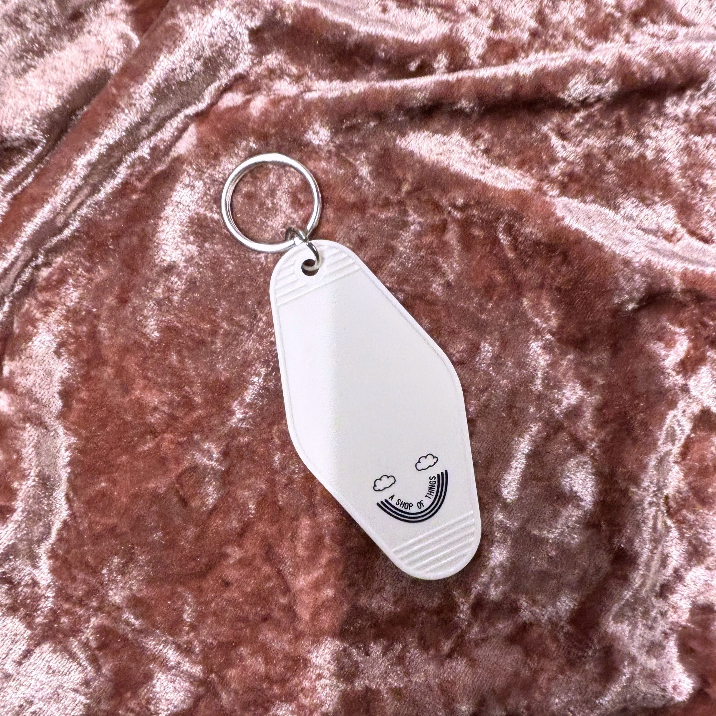 White vintage motel keychain featuring mood stabilizer design, from The Bullish Store, ideal for keys or as a collectible accessory.