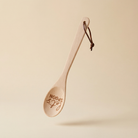 Let's Spoon beech wood cooking spoon with engraved sayings, displayed in a canvas gift bag for kitchen use and gifting.
