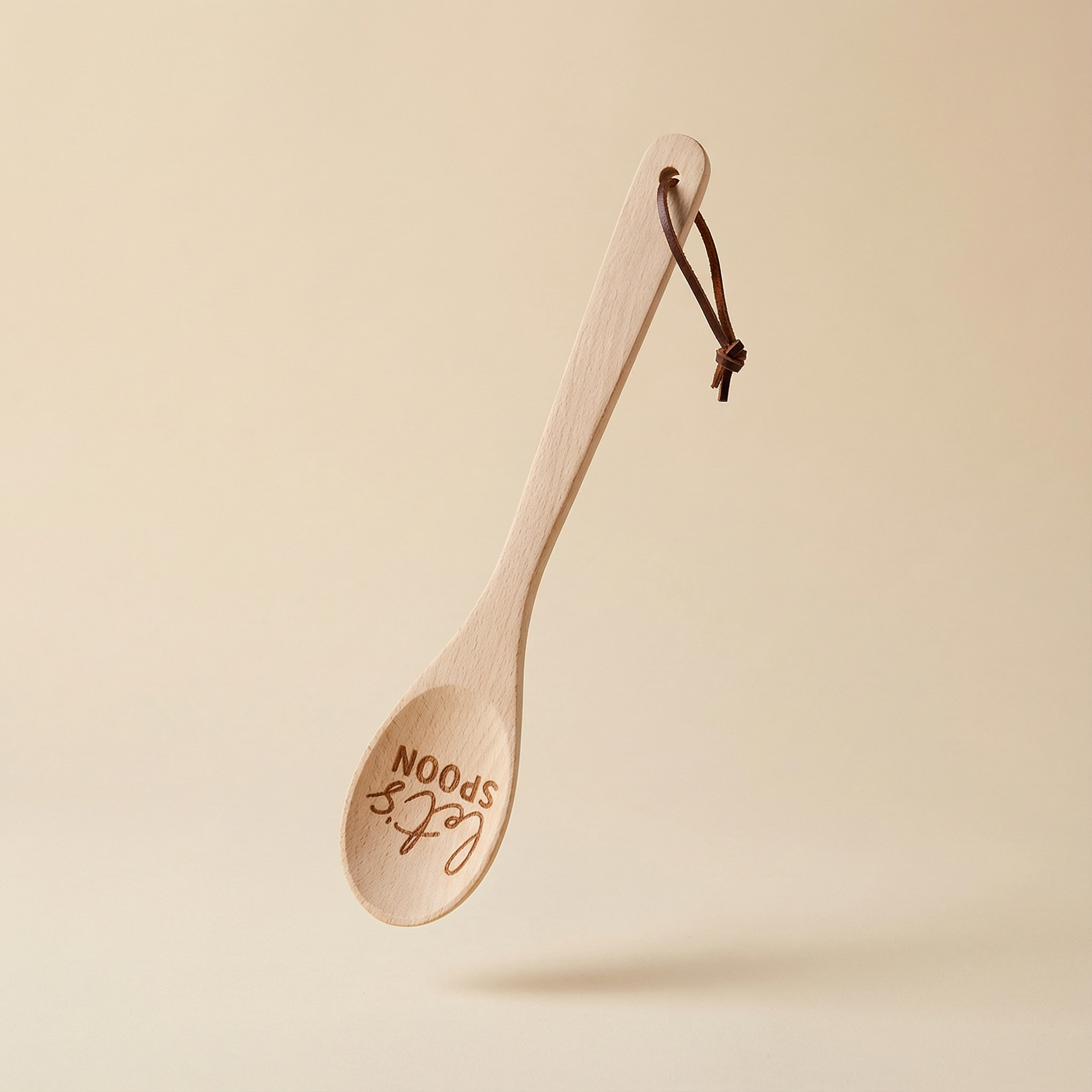 Let's Spoon beech wood cooking spoon with engraved sayings, displayed in a canvas gift bag for kitchen use and gifting.