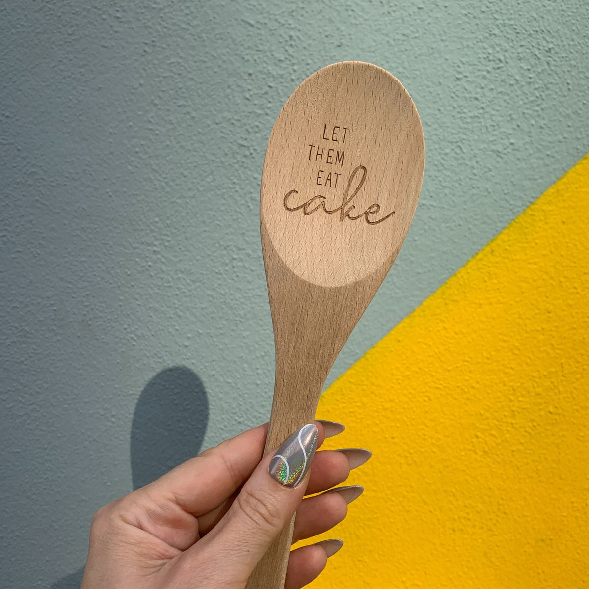 Marie Antoinette inspired wooden cooking spoon from The Bullish Store, displayed in a muslin gift bag, with charming design and sayings.