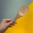 Marie Antoinette inspired wooden cooking spoon from The Bullish Store in muslin gift bag, featuring charming design and sayings.