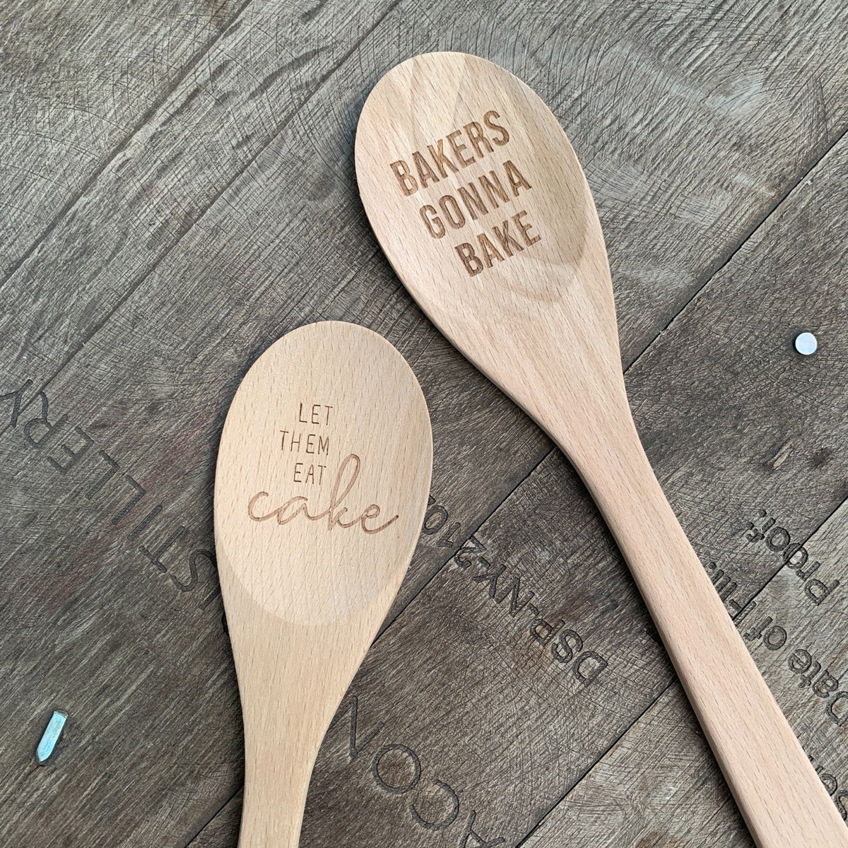 Marie Antoinette inspired wooden cooking spoon from The Bullish Store in muslin gift bag, featuring cute sayings and kitchen utensils.