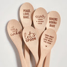 Wooden cooking spoon with "Peace. Love. Bake." engraved, presented in a muslin gift bag, from The Bullish Store kitchen utensils collection.