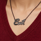 Sourpuss “Evil” pendant necklace with black rhinestones, gothic statement jewelry, featuring a dark, edgy design.