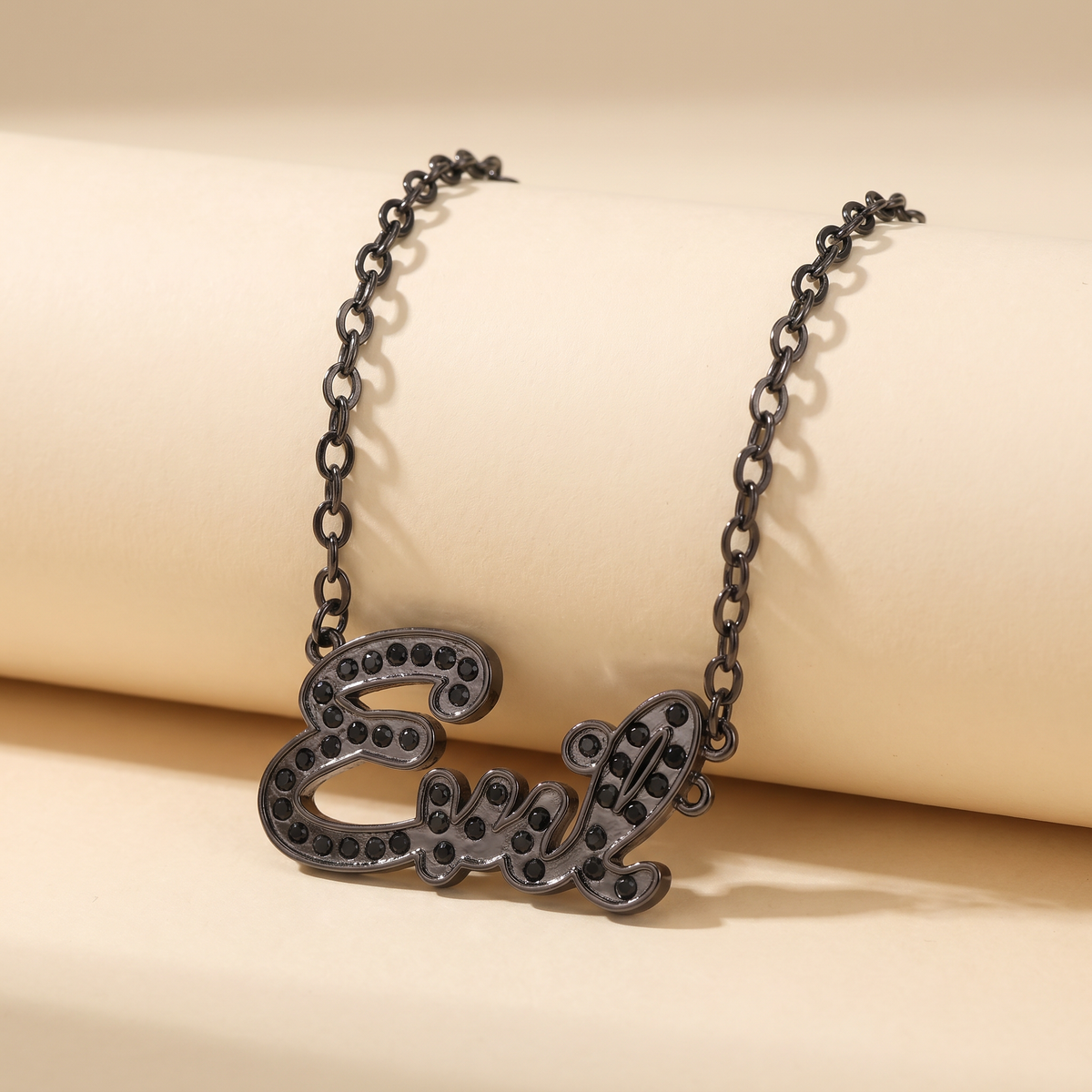 Sourpuss "Evil" pendant necklace with black rhinestones, gothic statement jewelry featuring a dark, edgy design.
