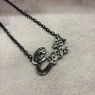 Sourpuss "Evil" pendant necklace with black rhinestones, Gothic statement jewelry featuring a dark, edgy design.