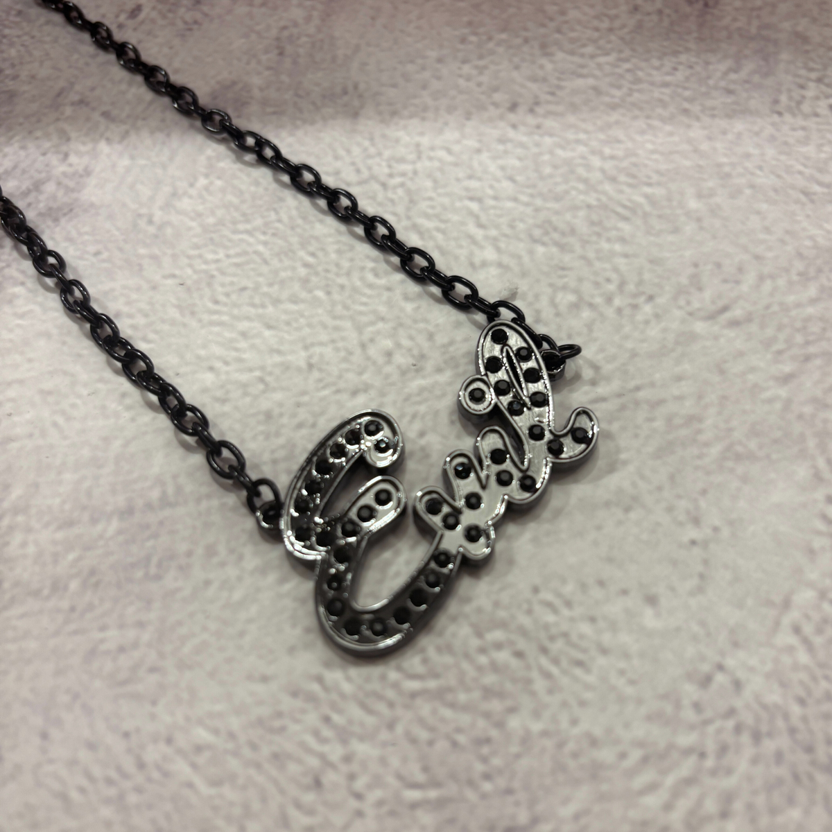 Sourpuss "Evil" pendant necklace with black rhinestones, Gothic statement jewelry featuring a dark, edgy design.