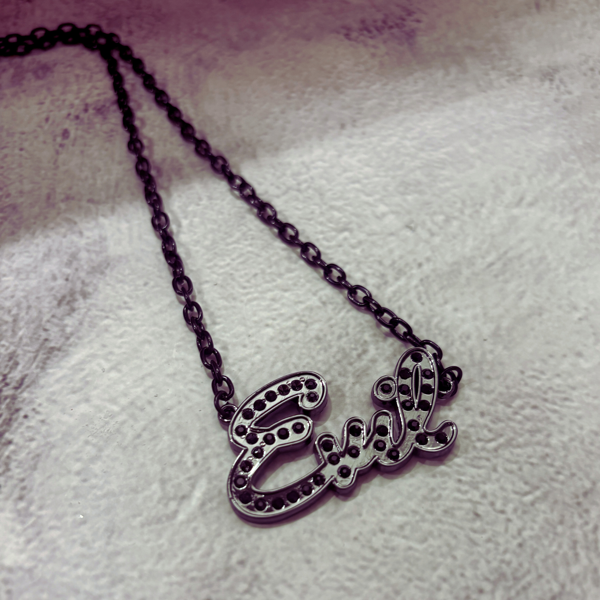 Sourpuss "Evil" pendant necklace with black rhinestones, gothic statement jewelry, featuring a detailed evil-themed design.